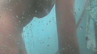Sizzling young couple taking an outdoor steamy shower sex